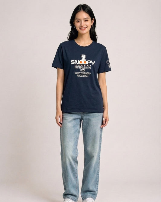 Woman wearing a navy blue Peanuts Snoopy First Beagle on the Moon graphic t-shirt
