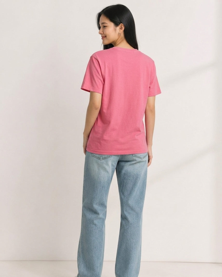 Woman wearing a pink short-sleeve crewneck t-shirt viewed from the back