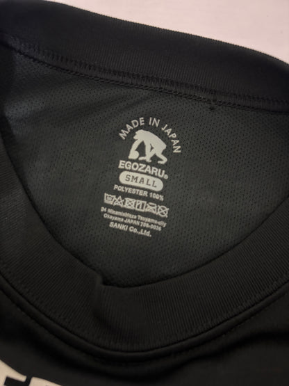 Close-up detail of the white Egozaru box logo printed on the upper back neckline of a black sports t-shirt