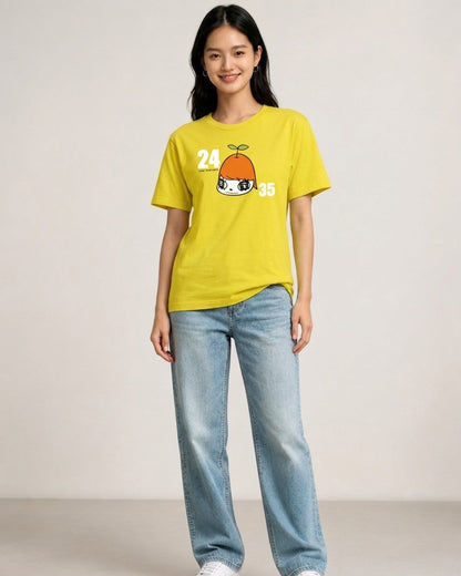 Woman standing in full view wearing a yellow Yoshitomo Nara x 24 Hour Television 2012 charity t-shirt with orange character and numbers 24 35, paired with light wash blue jeans.